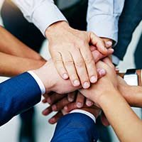 Group of people holding hands.